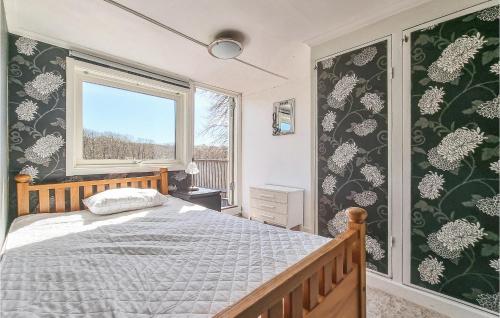 a bedroom with a bed and a window at Nice Home In Långekärr With Kitchen in Klövedal