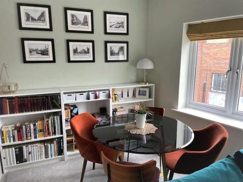 a dining room with a glass table and chairs at The Flat on Humber Street in Hull