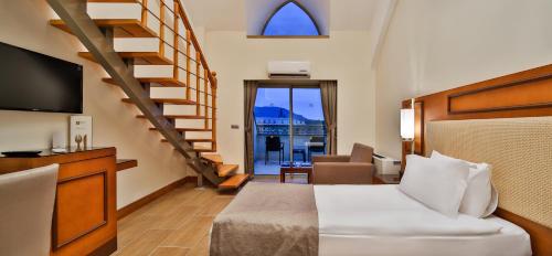 a hotel room with a bed and a staircase at Crystal Prestige Elite in Kemer