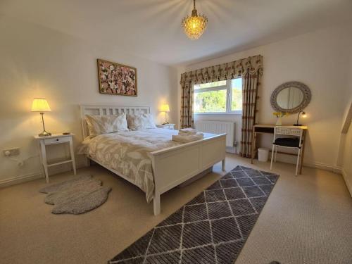 a bedroom with a large bed and a window at Large Modern Victorian Apartment in Ventnor