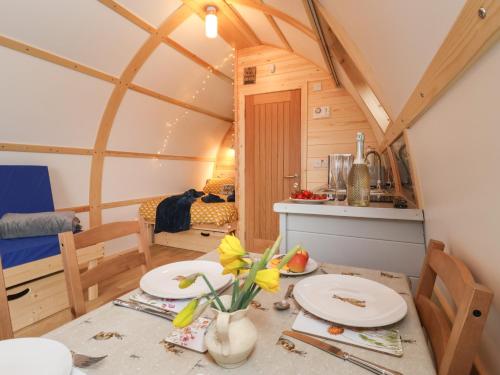 a small room with a table in a tiny house at Bevy in Harpham