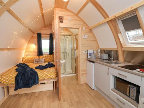 a small room with a bed in a tiny house at Bevy in Harpham