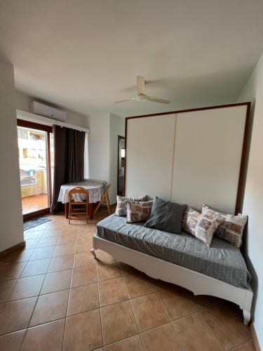 a bedroom with a bed with a large headboard at Studio's Pavese in Olbia