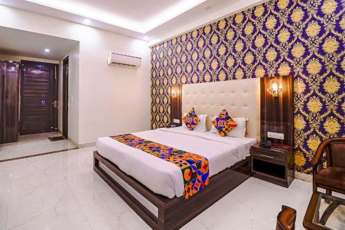 a bedroom with a large bed in a room at FabHotel Swess Grand in Agra