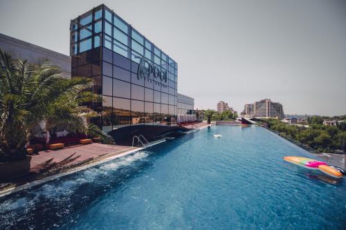 a swimming pool in front of a building at Seven Visions Resort and Places, the Dvin in Yerevan