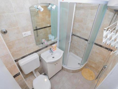 a bathroom with a shower and a toilet and a sink at Downtown apartment Tango in Zadar