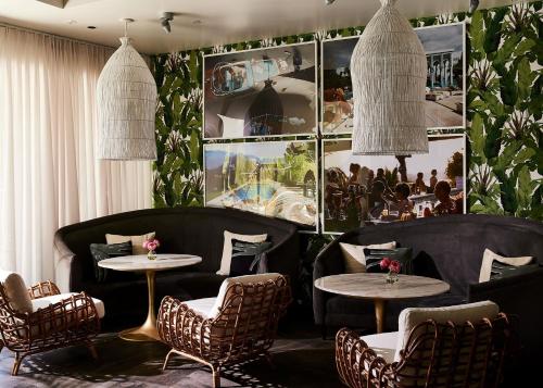 a restaurant with tables and chairs and pictures on the wall at Kimpton Sawyer Hotel by IHG in Sacramento