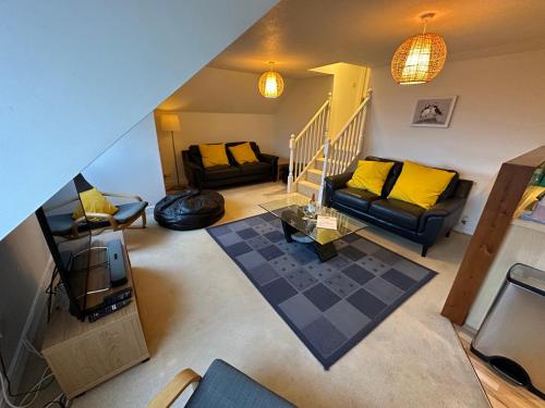 an overhead view of a living room with yellow pillows at Southover Beach in Woolacombe