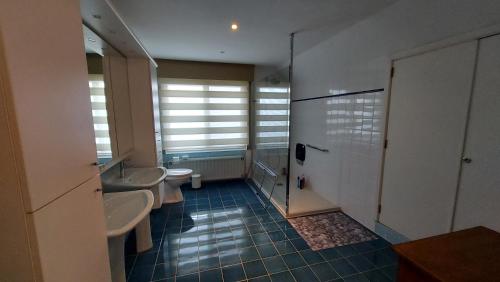 a bathroom with two sinks and two toilets at Villa Duinberg R-002 in Koksijde