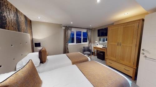 Ein Bett oder Betten in einem Zimmer der Unterkunft Tynedale Hotel