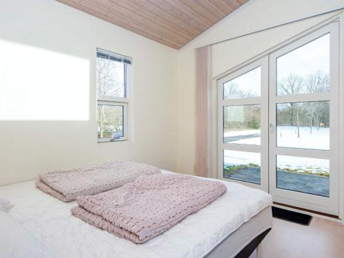 a white bedroom with a bed and a window at 6 person holiday home in Vemb-By Traum in Vemb