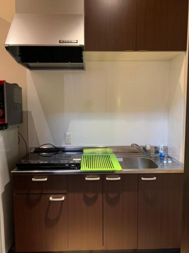 a kitchen with a sink and a stove at 翠云間 庭院式京町屋 京都四条西院 in Kyoto