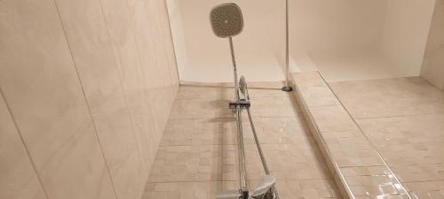 a shower in a bathroom with a tiled floor at Apollo 5 - Luxury Apartment (City Center Studio) in Katerini
