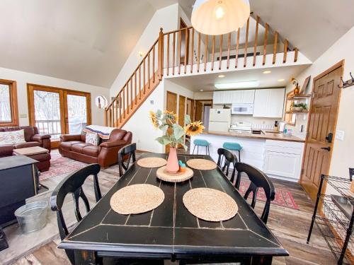 a kitchen and living room with a table and chairs at Lovely and Comfy Cabin Surrounded by Aspens and Wildlife - Aspen Acres in Fairplay