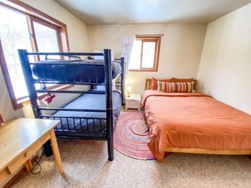 a bedroom with a bunk bed next to a bed gmaxwell gmaxwell gmaxwell at Lovely and Comfy Cabin Surrounded by Aspens and Wildlife - Aspen Acres in Fairplay