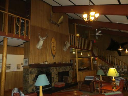 a living room filled with furniture and a fireplace at Black Cat Guest Ranch in Brule Mines