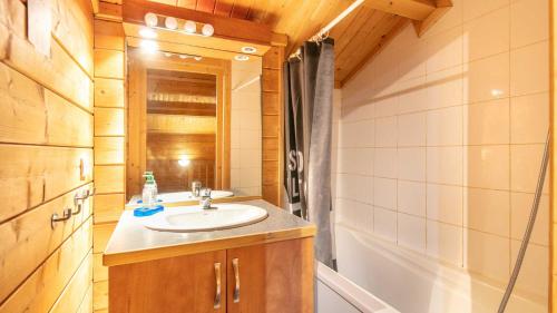 a bathroom with a sink and a bath tub at Bois de Champelle - 14 - Chalet cosy - 6 pers in Morillon