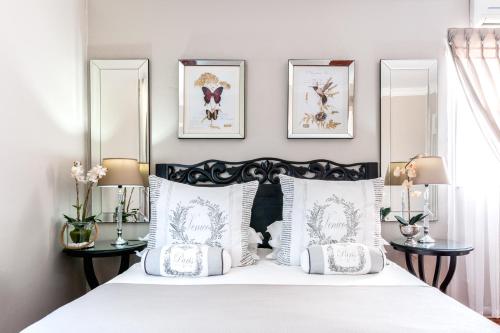 a bedroom with a black and white bed with mirrors at Adato Guesthouse in Potchefstroom