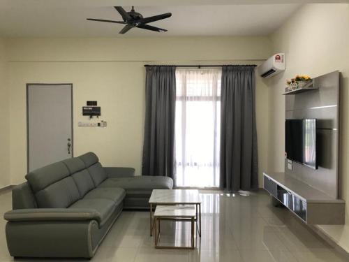 ein Wohnzimmer mit einem Sofa und einem Deckenventilator in der Unterkunft 88 Cozy House in Kuala Selangor