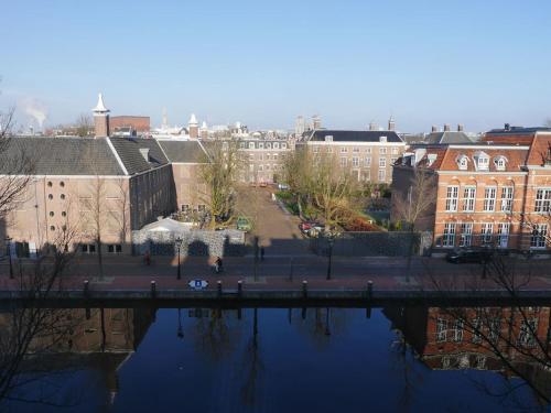 a view of a city with a river and buildings at Hotel Adolesce in Amsterdam