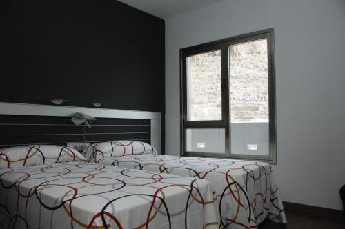 a bedroom with a bed and a window at Hotel La Colombina in San Sebastián de la Gomera