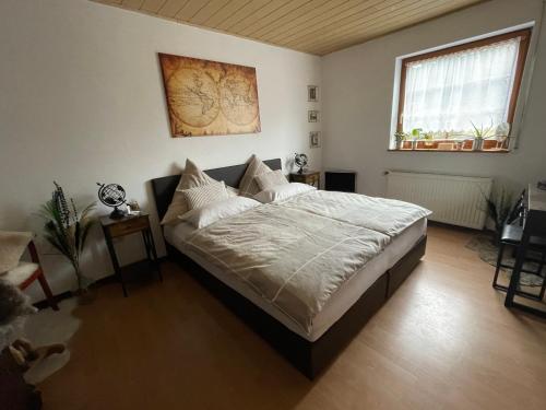 a bedroom with a large bed in a room at Ferienwohnung in der Vulkaneifel "Opp der Holl" in Brockscheid
