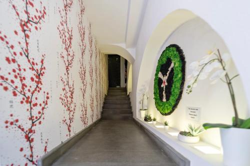a hallway with stairs and plants on the wall at Ukiyo Suites And Rooms in Cagliari