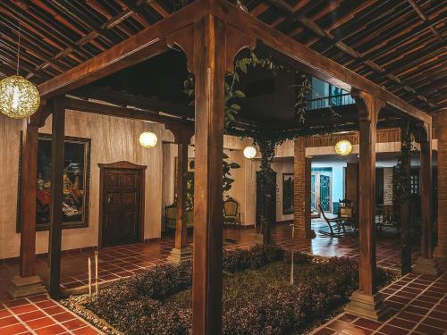 a living room with a large wooden structure with a ceiling at Casona Montanesa Quindío eje cafetero in Montenegro