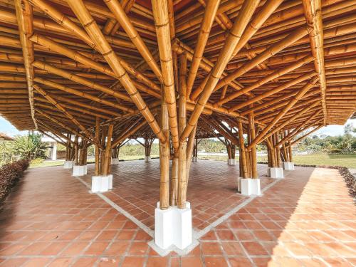 a large wooden pavilion with a brick floor at Casona Montanesa Quindío eje cafetero in Montenegro