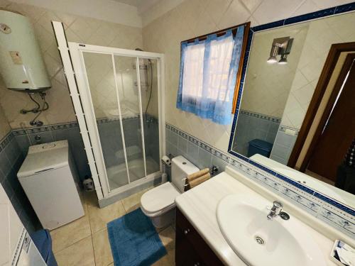 a bathroom with a sink and a toilet and a shower at Pier View Los Cristianos Free WiFi in Los Cristianos