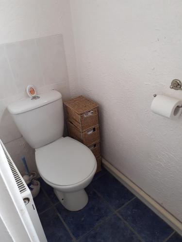a bathroom with a toilet and a roll of toilet paper at Home from home Single or double room Netflix or Virgin TV Wifi & free parking in Poole
