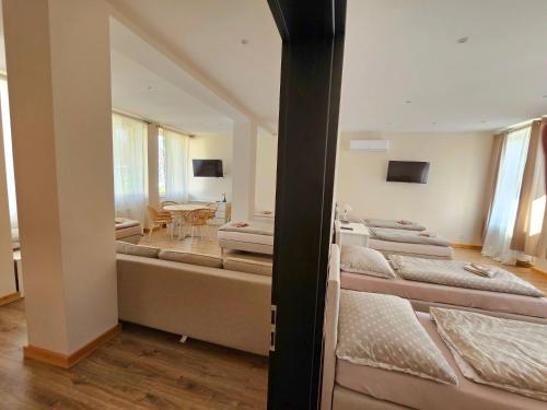 a room with a row of beds and a table at Ustroń51 in Ustroń
