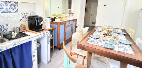 a kitchen with a table with plates of food on it at B & B LuVì in Vibo Valentia