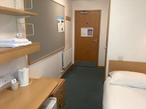 a hospital room with a bed and a door at University of Exeter - Pennsylvania Court in Exeter