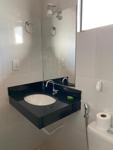 a bathroom with a sink and a mirror at Suíte Aconchego Mineiro in Ouro Preto
