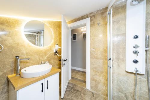 a bathroom with a sink and a shower at Nature Sea View Flat with Jacuzzi in Kas Antalya in Kas
