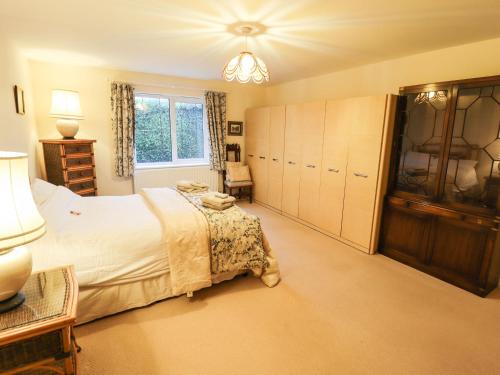 a large bedroom with a bed and a window at Acer Cottage in Boston