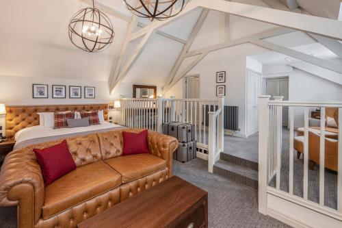 a living room with a bed and a couch at De Vere Tortworth Court in Wotton under Edge