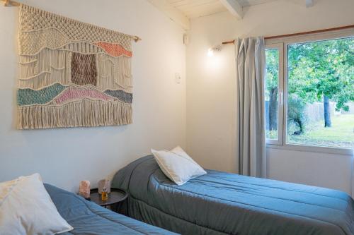 a bedroom with two beds and a window at Don Antonio Hospedaje & Espacio Coworking in Rawson