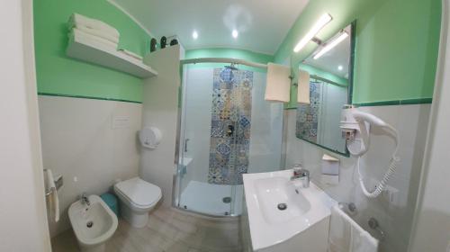 a bathroom with a shower and a sink and a toilet at Sicilia Bedda Taormina in Taormina