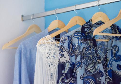 a group of blue and white clothes on hangers at Sarantis Suites & Apartments in Provatas