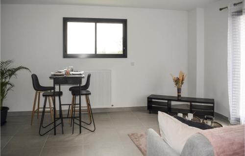 a living room with a table and chairs in it at Stunning Apartment In Lantic With Wifi in Lantic