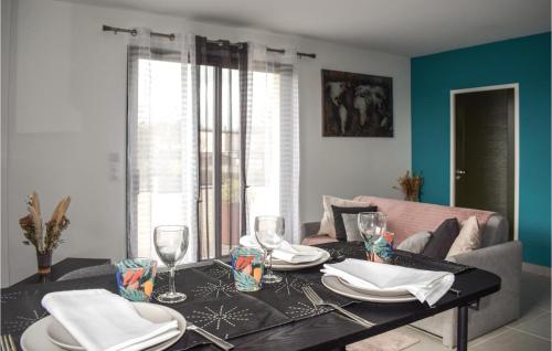 a dining room table with plates and wine glasses at Stunning Apartment In Lantic With Wifi in Lantic