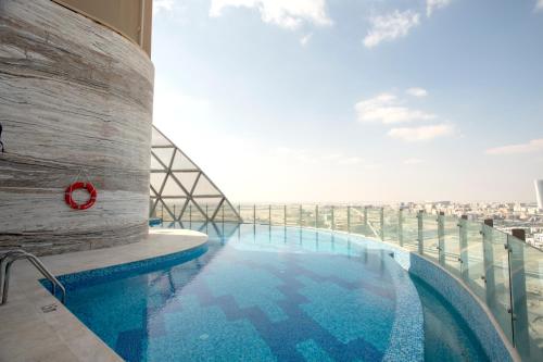 a swimming pool on the top of a building at Century Marina Hotel - Lusail in Lusail