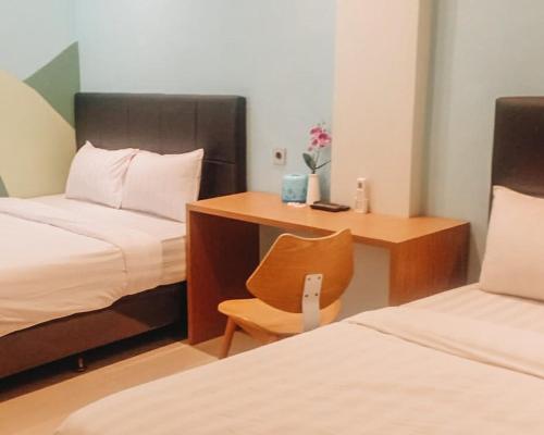 Postel nebo postele na pokoji v ubytování Capital Hotel