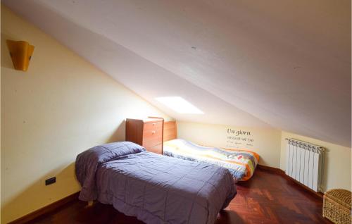 a bedroom with a bed in a attic at 4 Bedroom Cozy Apartment In Rogliano in Rogliano