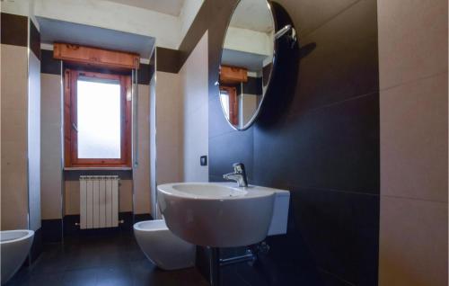 a bathroom with a sink and a mirror at 4 Bedroom Stunning Apartment In Rogliano in Rogliano