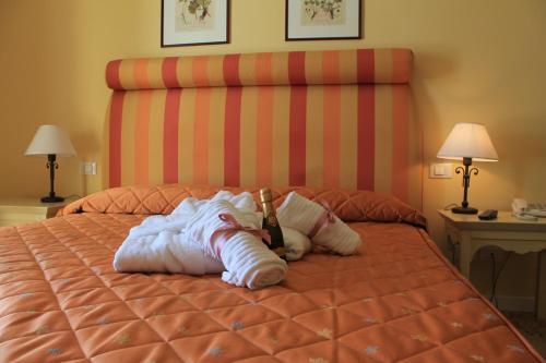 a stuffed animal is laying on a bed at Il Parco Sul Mare Resort & SPA in Tortoreto Lido