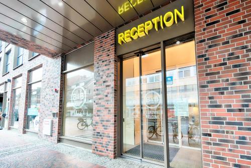 a store front of a brick building with a reporation sign at B&B Hotel Emden in Emden