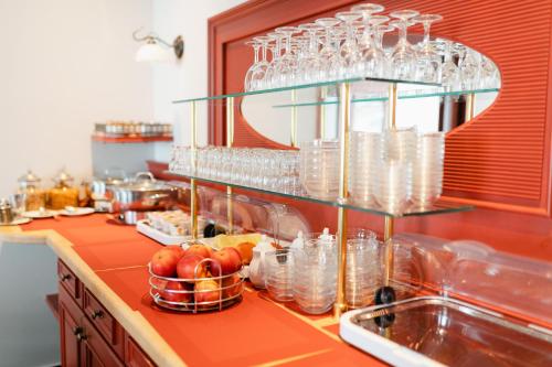 a kitchen with a counter with glasses and a sink at Hotel am Denkmal Norderney in Norderney